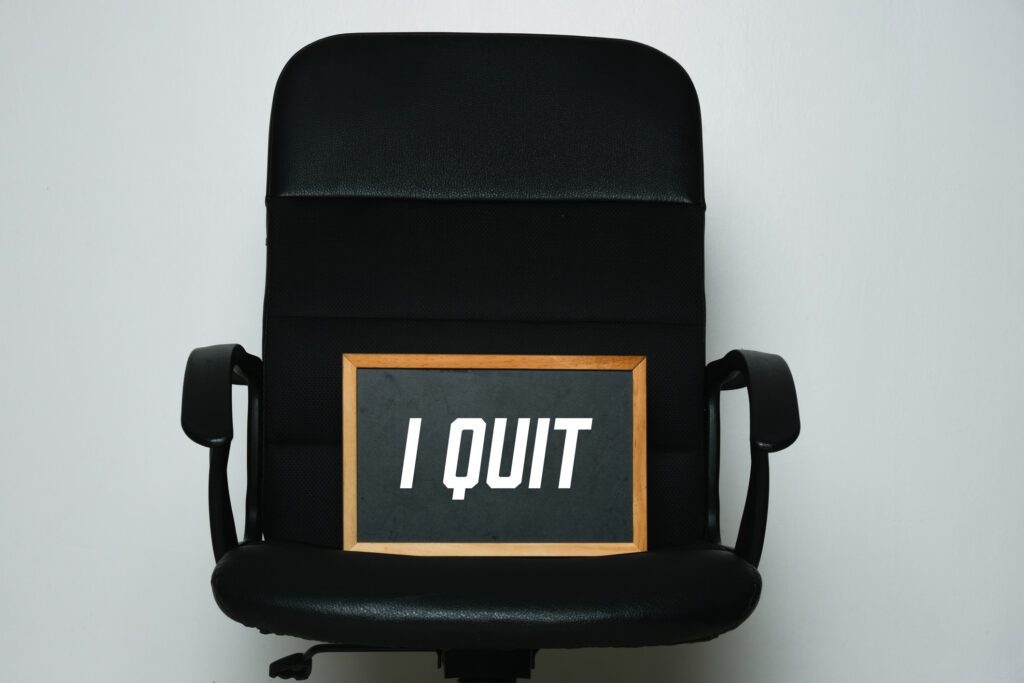 A Black Chair With I Quit Board on it