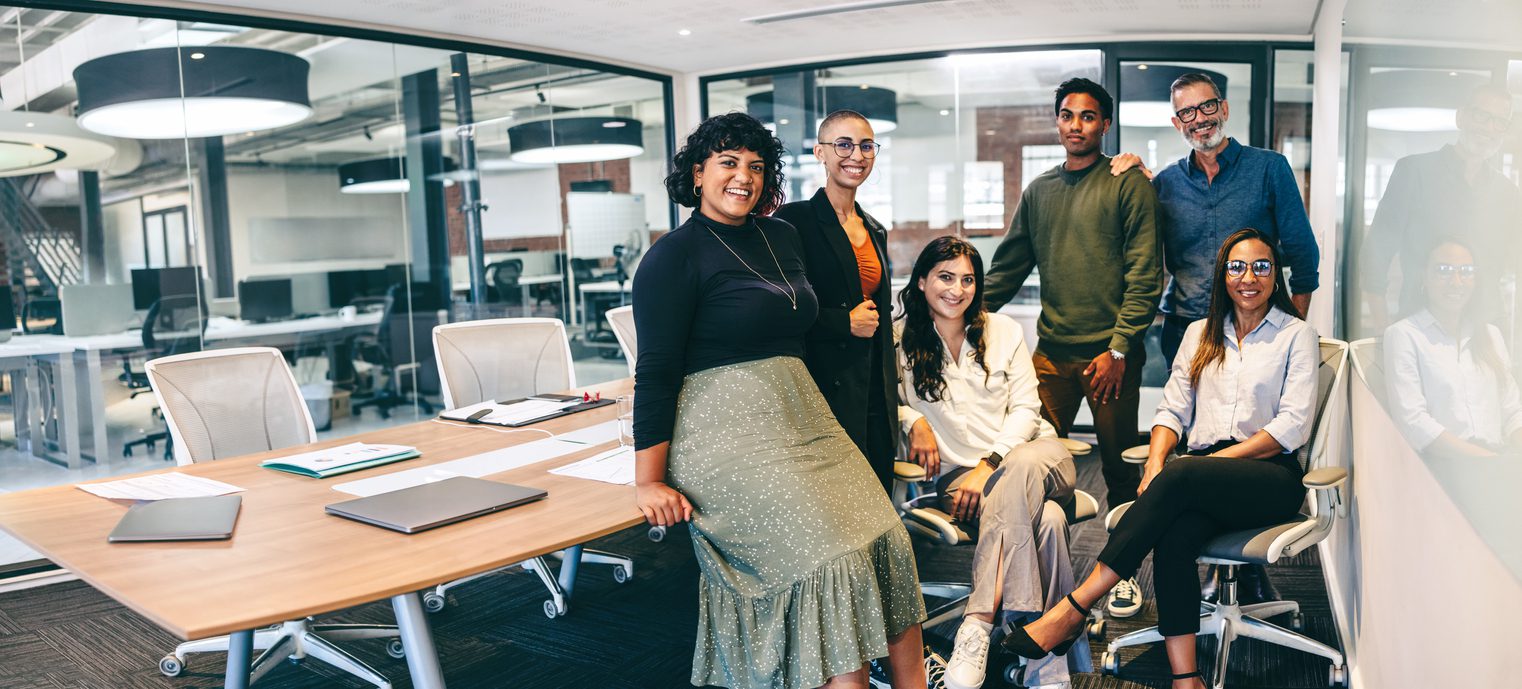 A group of people standing in an office.