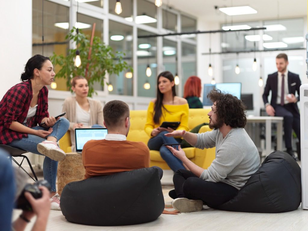 A group of people sitting around in an office.