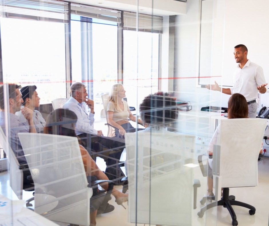 Business meeting in a glass office.