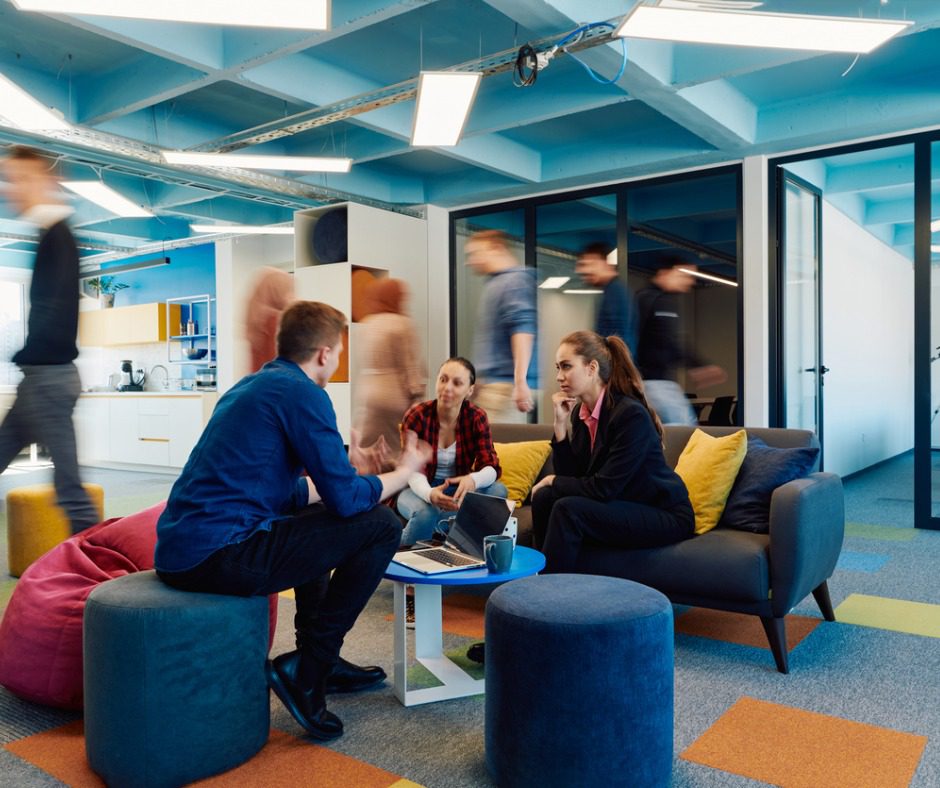 Four people meeting in a modern office.